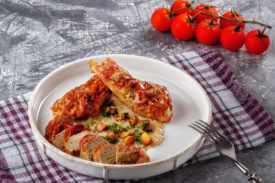 Chicken drumstick ballotin with onion sauce and mushrooms. Stuffed chicken legs