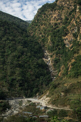 Fototapeta na wymiar High waterfall flowing in the nepalese mountains, Annapurna circuit, Nepal
