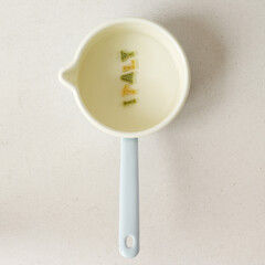 Some alphabet pasta being arranged into a word