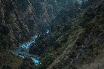 Beautiful Marshyangdi river flowing through a canyon valley underneath rock stairs, Annapurna circuit, Nepal