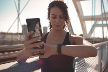 Fitness woman using smart phone and smart watch