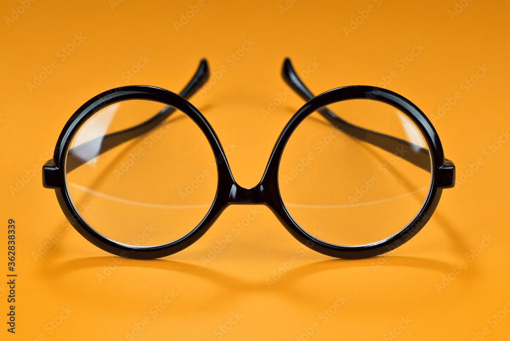 Poster different types of glasses on a yellow background close up. glasses with round frames.