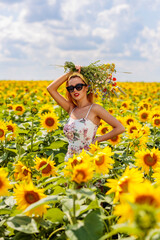 Pretty young woman on a sunflowers field
