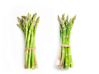 Two bunchs of asparagus on a white isolated background. Flat lay. The concept of proper nutrition.