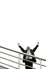 Businessman screaming while raising his hands