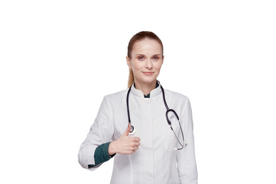 Beautiful female doctor in medical coat showing thumbs up gesture.