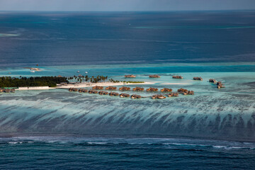 Aerial view of the Maldivian atolls the islands in the ocean with carols and the turquoise beautiful water - 362840588