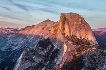 Fototapeta premium The half dome and Yosemite Valley at sunset, shot at glacier point in Yosemite National Park, California.