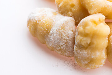 A pile of gnocchi on a white background