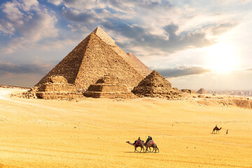 Fototapeta na wymiar The Pyramids in the desert of Giza, Egypt, sun and clouds scenery