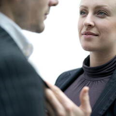 Businesswoman holding businessman's suit