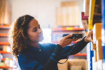 warehouse worker using bar code scanner to analyze newly arrived goods for further placement in...