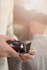Replacing the nozzle of an electric hair clipper. Hands change nozzles electric hair clippers. Replacing the clippers