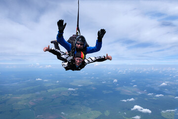 Skydiving. Tandem jump. Two guys are flying in the sky.