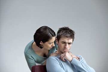 Woman consoling her sad boyfriend