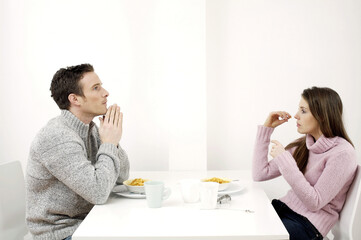 Obraz na płótnie Canvas Couple having breakfast cereal