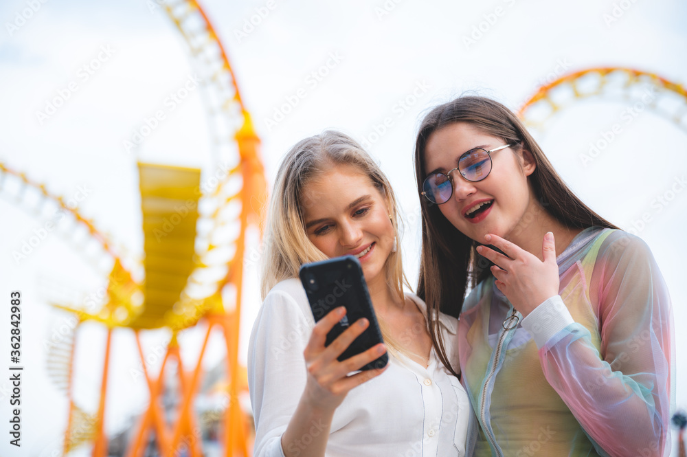 Wall mural group of happy best friends laughing and taking selfie photo at amusement park, holiday travel with 