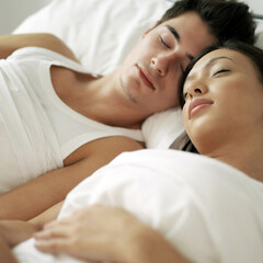 Obraz na płótnie Canvas Couple sleeping comfortably on the bed