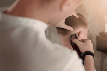 Men's hairstyling and haircutting in a barber shop or hair salon.