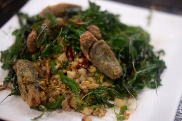 Spicy stir fried preserved eggs with crispy basil and minced pork
