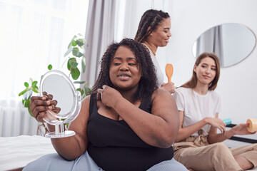 Three female mates of different races looking after their skin and hair