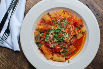 Rigatoni Pasta with meatballs, marinara sauce, Parmesan cheese and fresh Italian parsley. Classic American or Italian restaurant favorite. Homemade pasta with sauces, meats and cheeses.