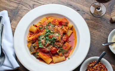 Rigatoni Pasta with meatballs, marinara sauce, Parmesan cheese and fresh Italian parsley. Classic American or Italian restaurant favorite. Homemade pasta with sauces, meats and cheeses.