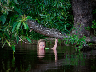 mermaid girls with blue eyes in green thickets in the water