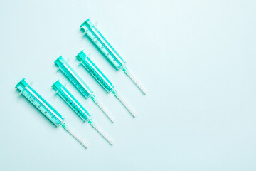 Top view of different syringes for injection on colorful background. Medical equipment concept with copy space