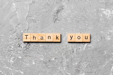 thank you word written on wood block. thank you text on table, concept