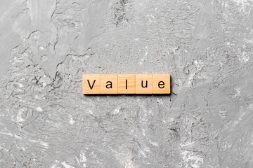 value word written on wood block. value text on table, concept