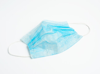 blue disposable medical mask on a white background