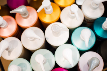 Multi-colored bottles with dispensers in a beauty salon, top view