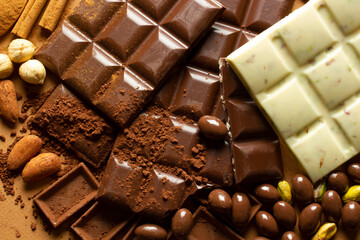 White and milk chocolates. Almond, pistachio, hazelnut.. background, texture..