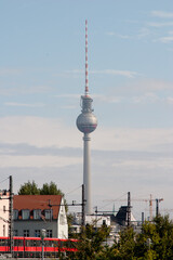 Berlin famous television tower seen in telephoto shot with S-bahn train in foreground