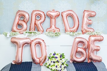 Bride to be balloon letters sign on the bed - bridal shower concept