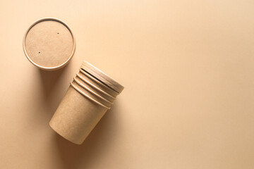 Craft paper soup cup on brown background. Empty container. Ecological individual package. Zero...