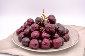 Fresh cherries on a plate.