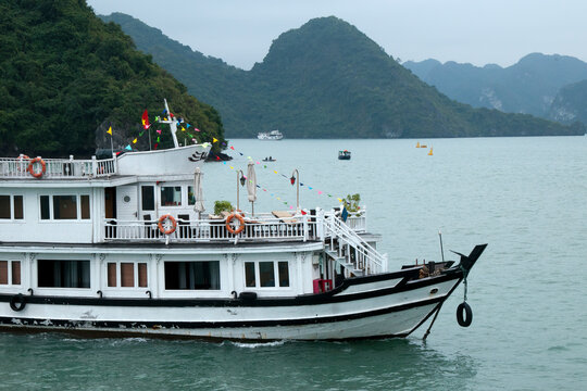 Ha Long Bay Vietnam, tourist boat moving around bay with krast formation in background