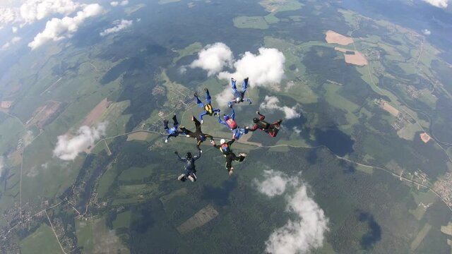 Skydiving. A group of skydivers is training in the sky.