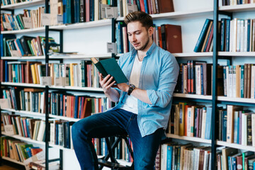 Content male reviewing book in bookstore