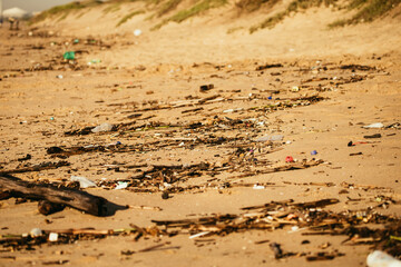 Trash Littering the Beach at Sunrise