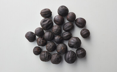 Top view shot of dried lime on white background.
loomi, limoo amani, black lime, persian lime
