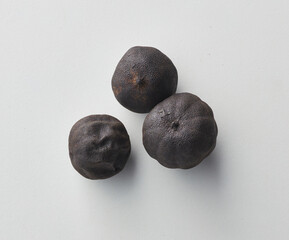 Top view shot of dried lime on white background.
loomi, limoo amani, black lime, persian lime