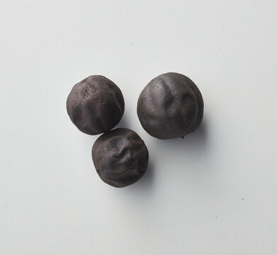 Top view shot of dried lime on white background.
loomi, limoo amani, black lime, persian lime