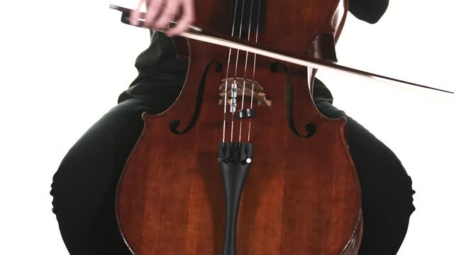 masterly musician in a black shirt performs a beautiful slow melody on a classical cello. Isolated. Medium long shot