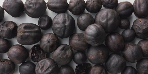Top view shot of dried lime on white background.
loomi, limoo amani, black lime, persian lime