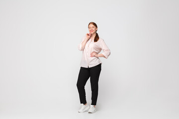 Happy. Young woman in casual wear on white background. Bodypositive character, feminism, loving herself, beauty concept. Plus size businesswoman during paperwork. Inclusion, diversity.