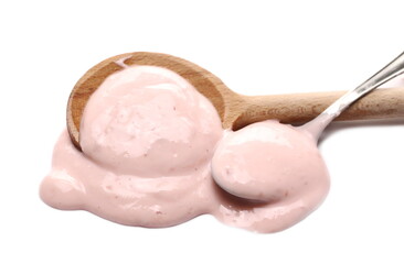 Strawberry fruit yogurt with wooden and metal spoon isolated on white background