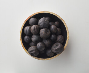 Top view shot of dried lime on white background.
loomi, limoo amani, black lime, persian lime